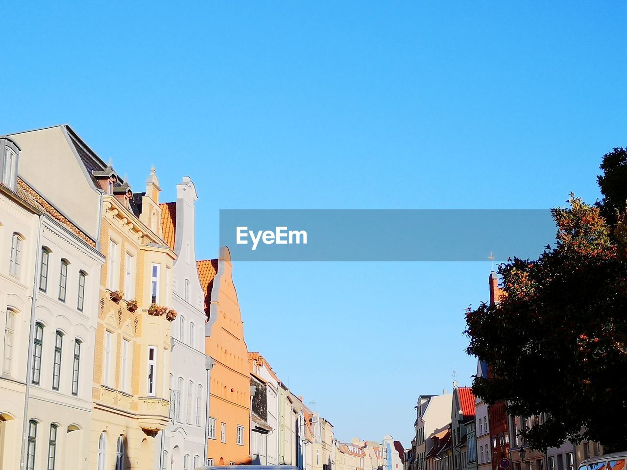 Low angle view of buildings against clear blue sky