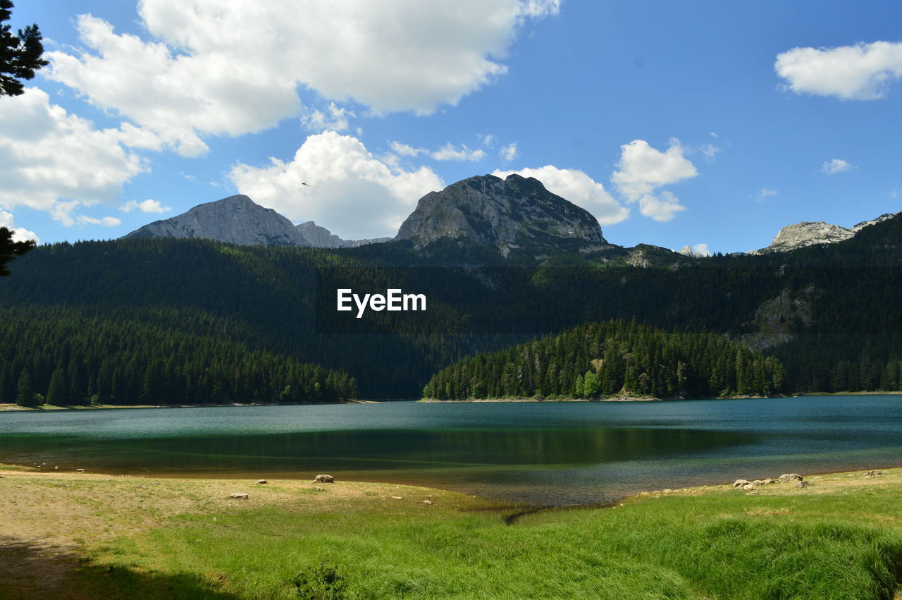 Scenic view of lake and mountains against sky