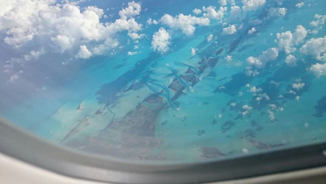 High angle view of sea seen through airplane glass window