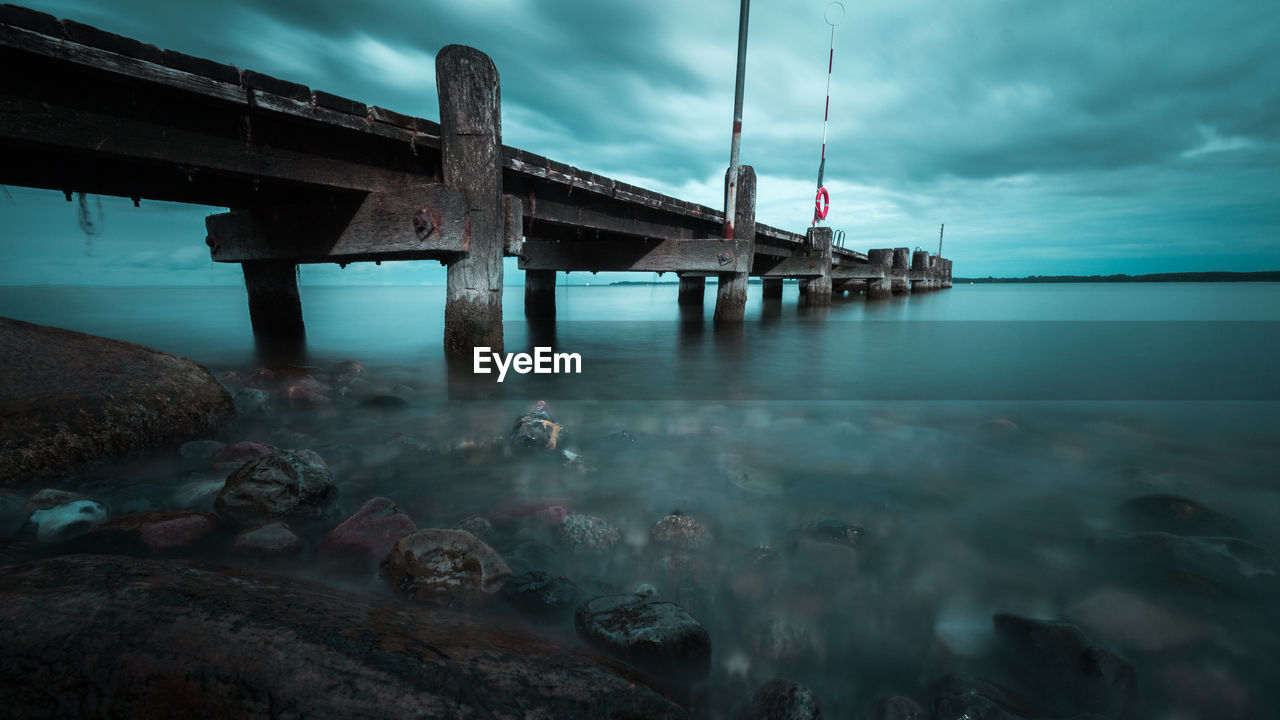 Pier over sea against sky