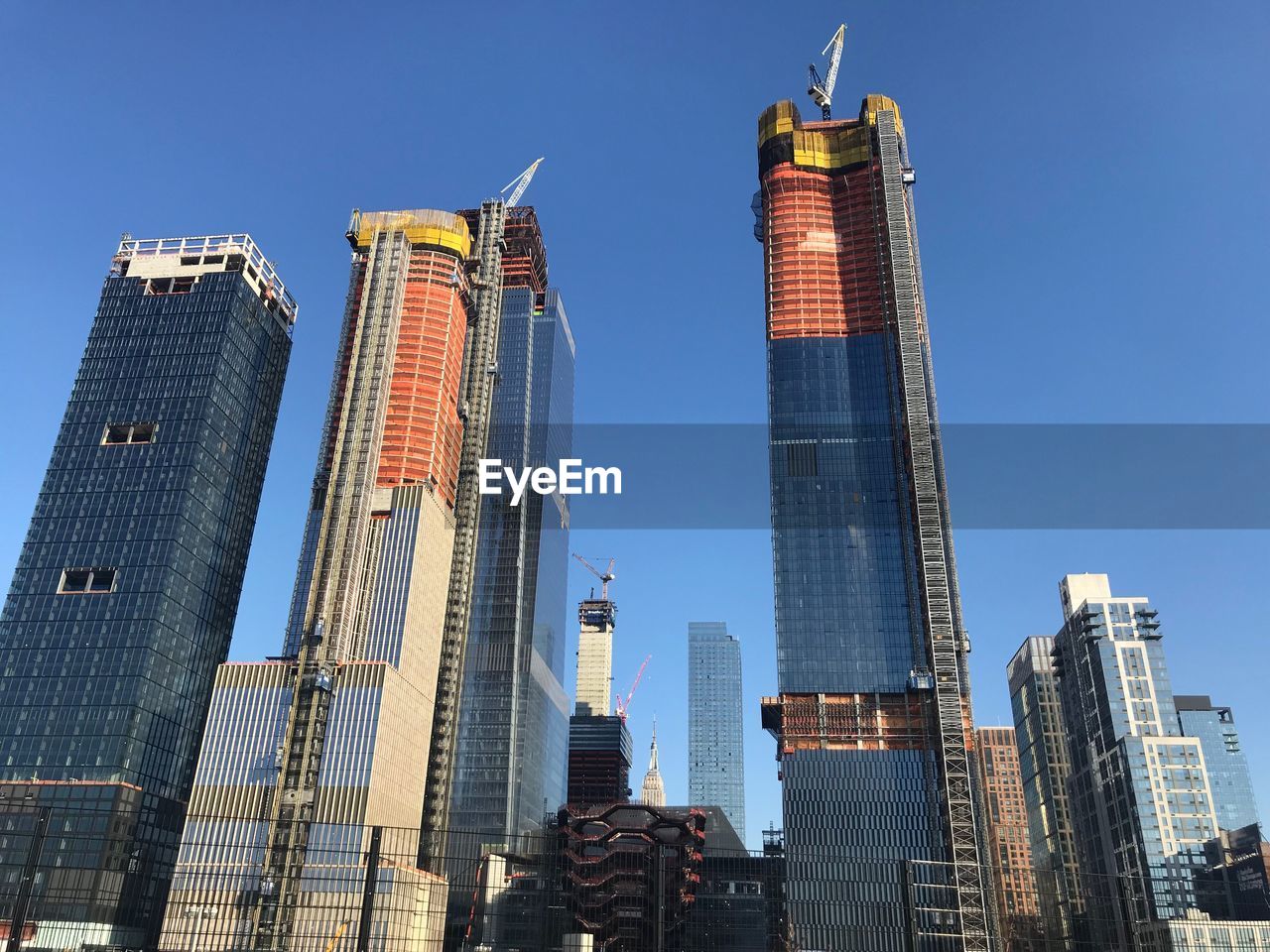 LOW ANGLE VIEW OF SKYSCRAPERS AGAINST BLUE SKY