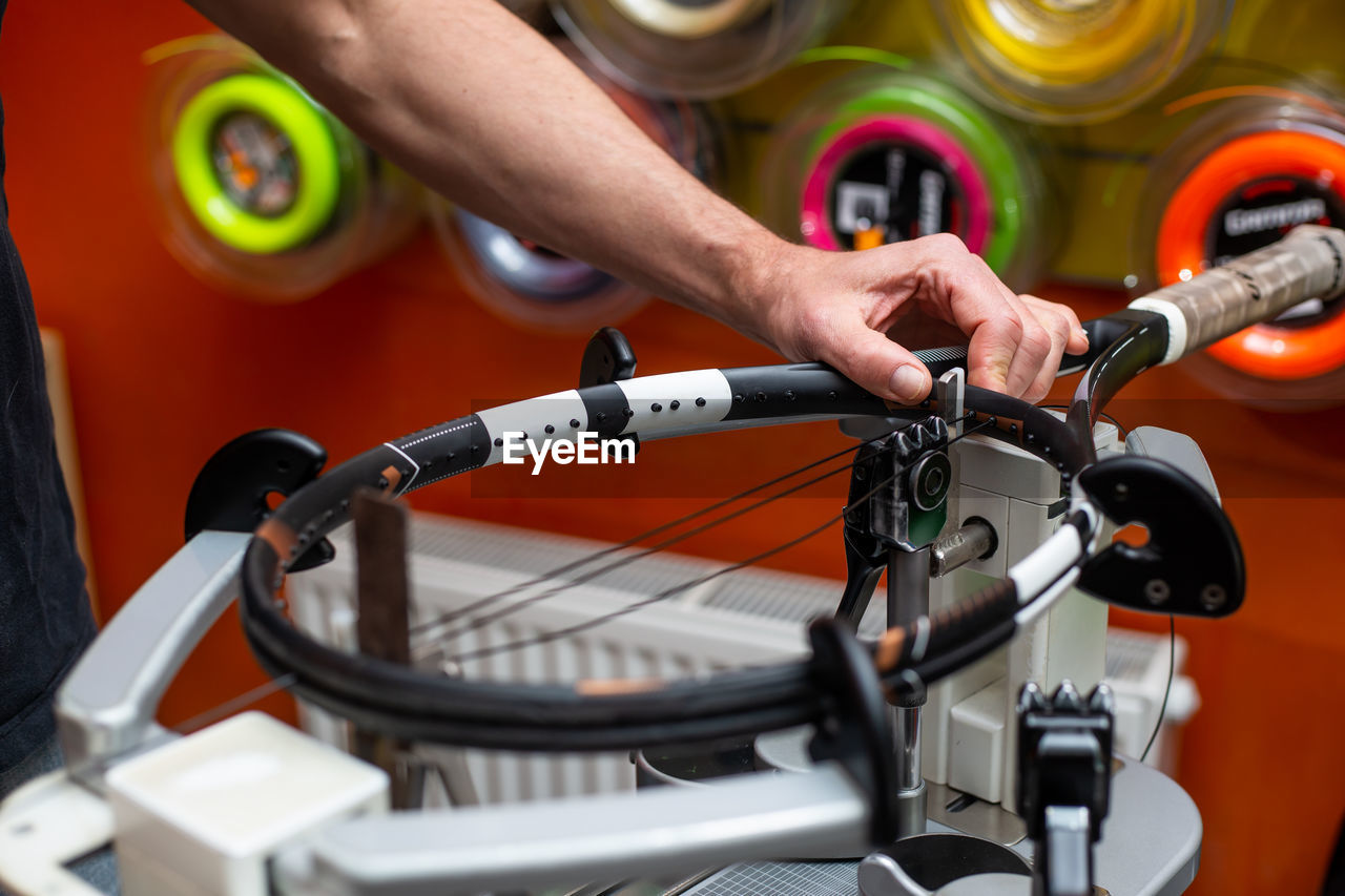 Process of stringing a tennis racket in a tennis shop, new tennis racket string