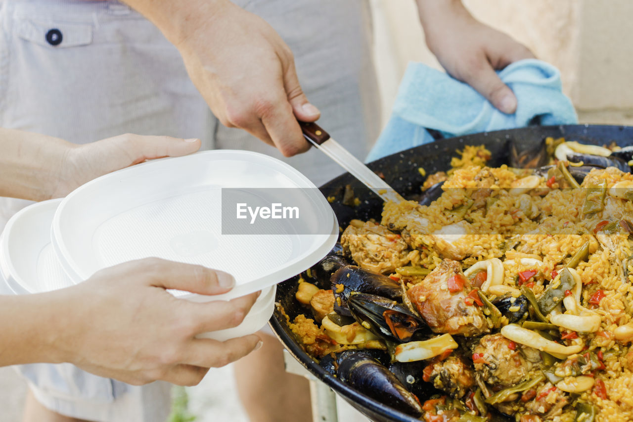 Chef serving typical spanish seafood paella