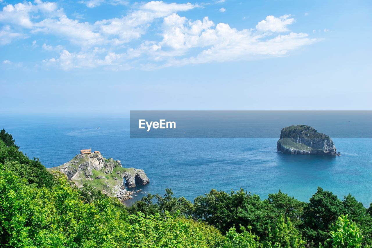 sea, water, sky, scenics - nature, land, beauty in nature, nature, horizon over water, plant, coast, cloud, horizon, ocean, beach, tree, tranquility, blue, tranquil scene, travel destinations, environment, travel, shore, no people, landscape, cliff, coastline, rock, outdoors, day, body of water, tourism, idyllic, bay, island, architecture, vacation, non-urban scene, mountain, seascape, islet, green, terrain, high angle view, trip, tropical climate, holiday