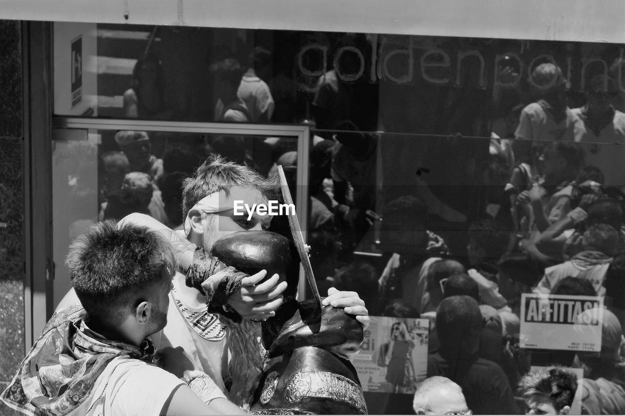 MEN AND PEOPLE IN MARKET STALL