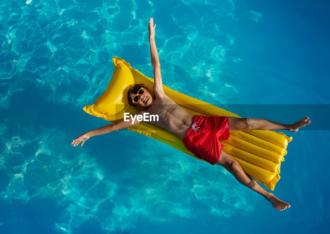 high angle view of woman swimming in pool