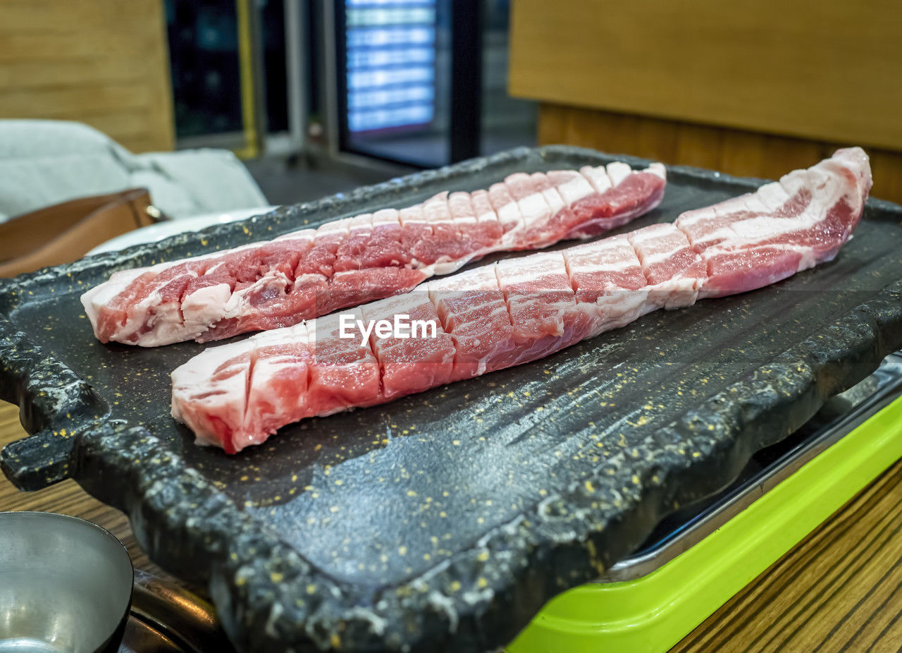 Close-up of pork belly on hot plate