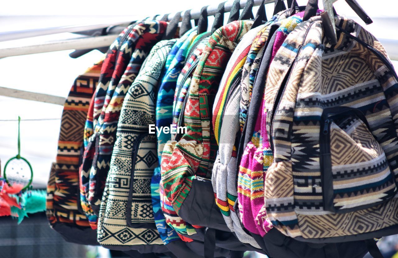 CLOSE-UP OF CLOTHES HANGING IN STORE FOR SALE IN SHOP