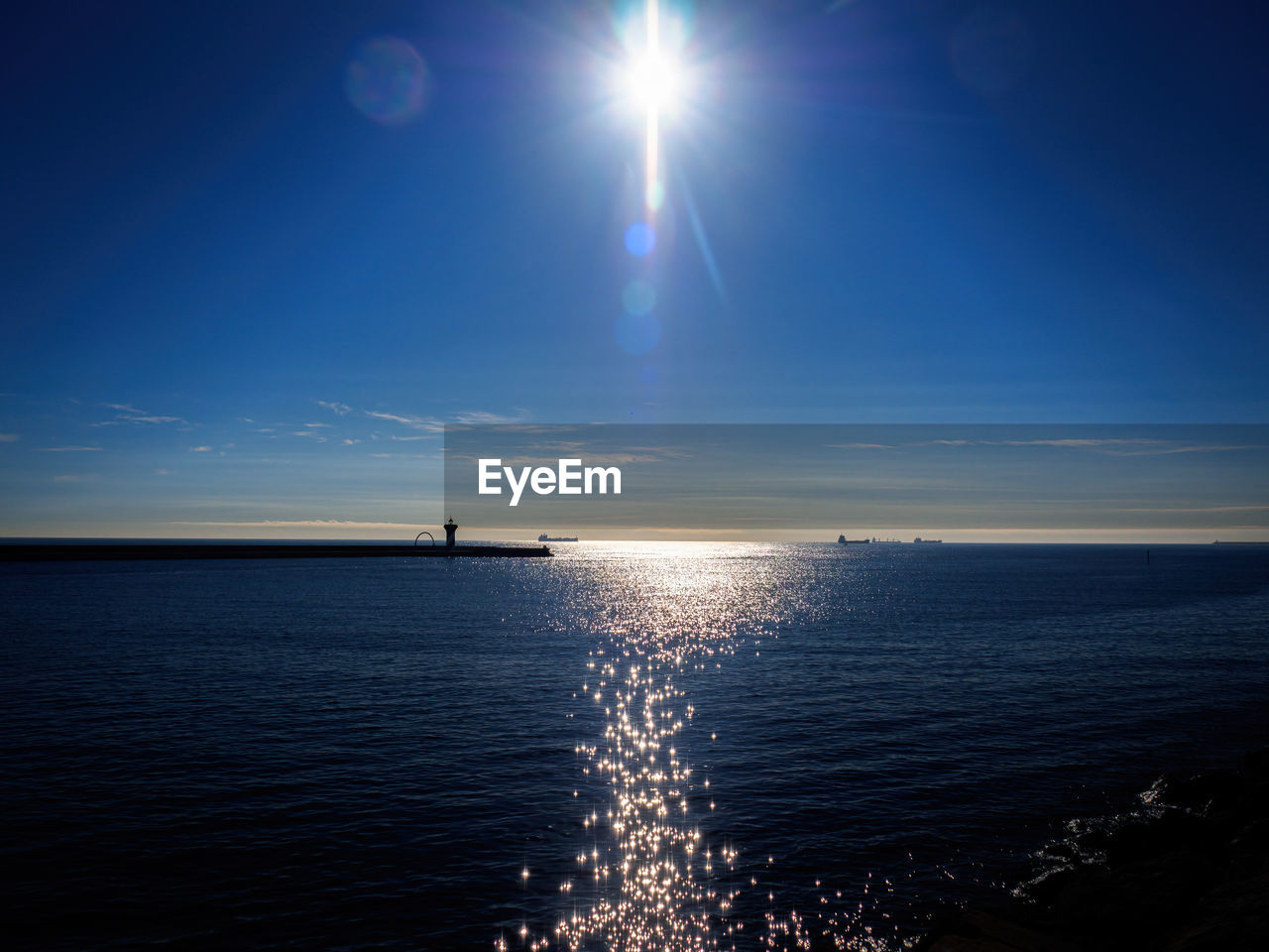 VIEW OF SEA AGAINST BRIGHT SUN