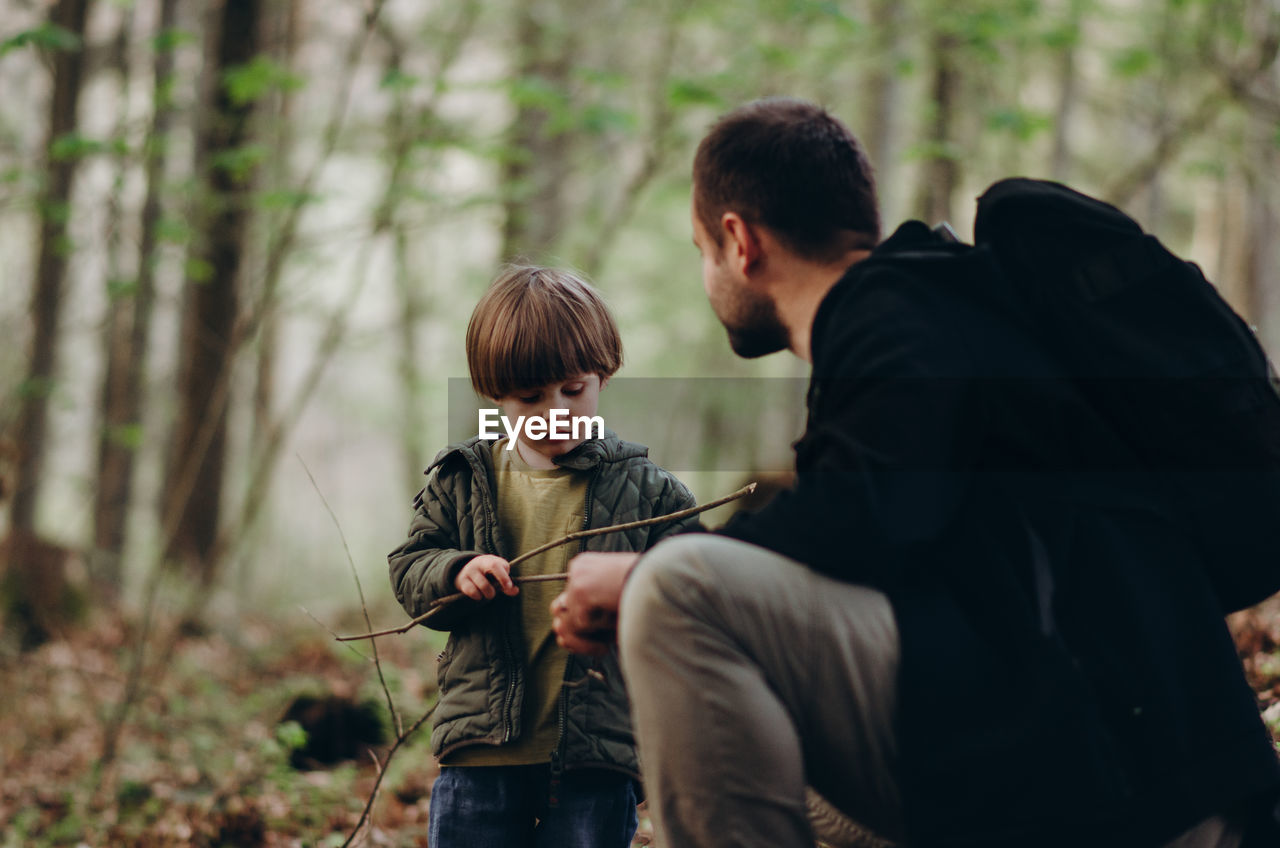 Father and son in forest