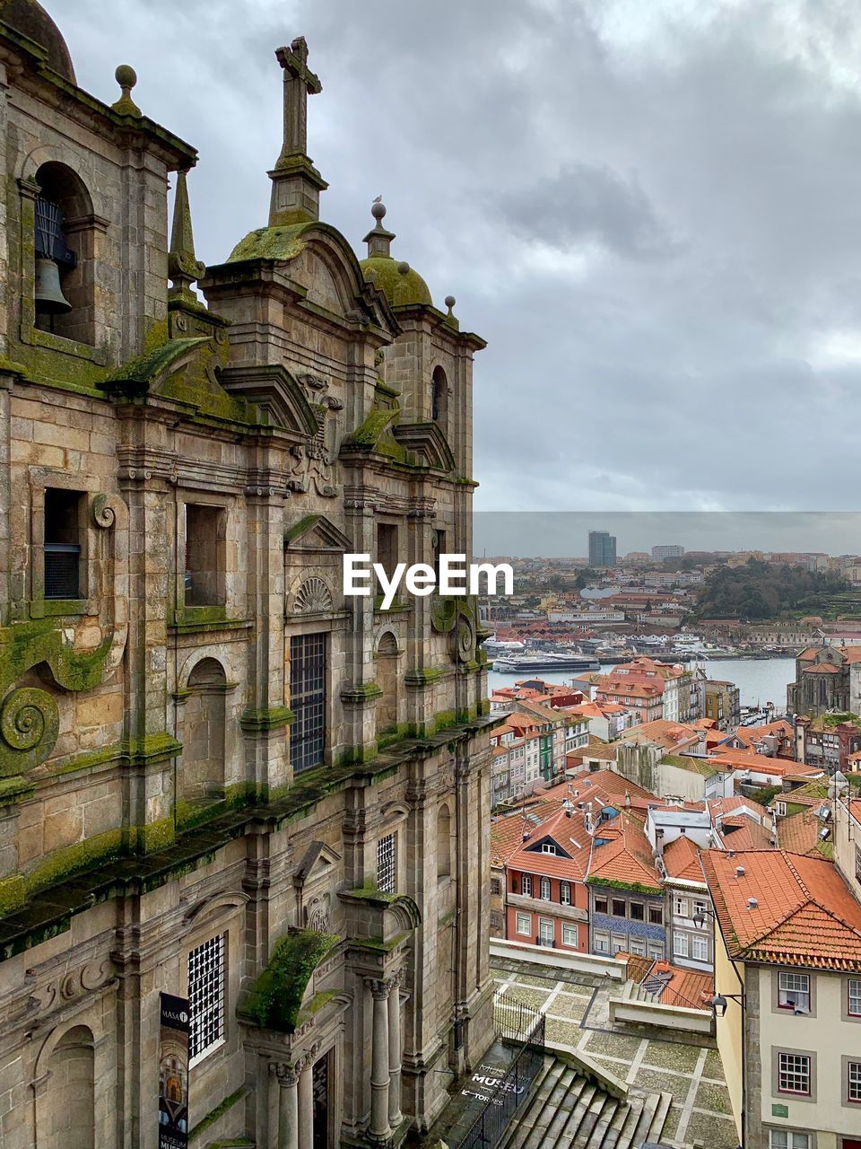 Buildings in city against cloudy sky