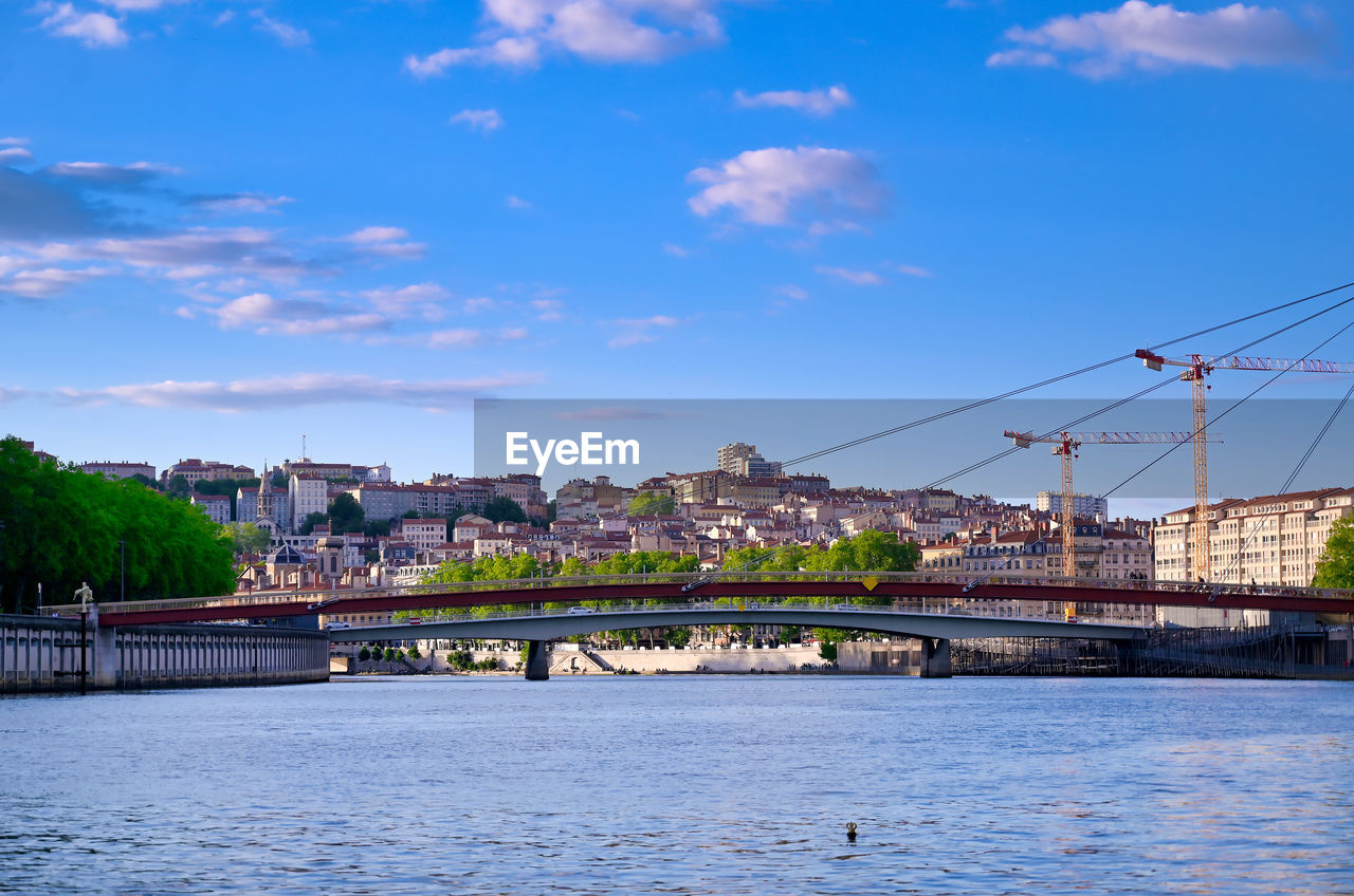 BRIDGE OVER RIVER AGAINST BUILDINGS