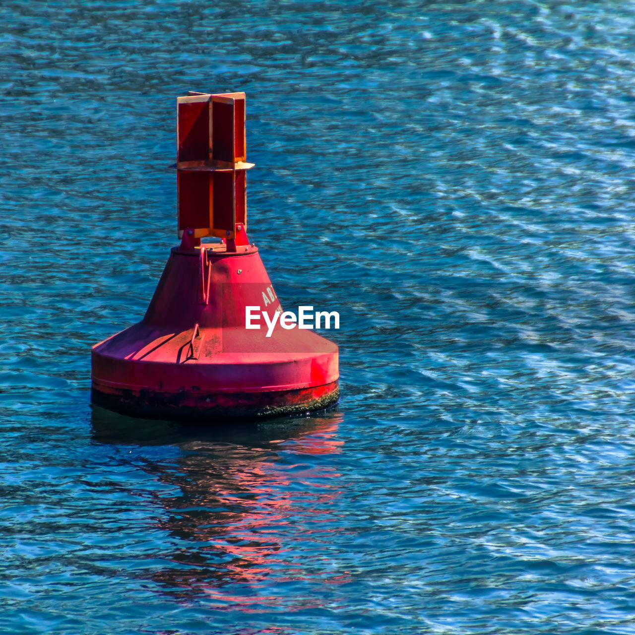 HIGH ANGLE VIEW OF RED FLOATING ON SEA