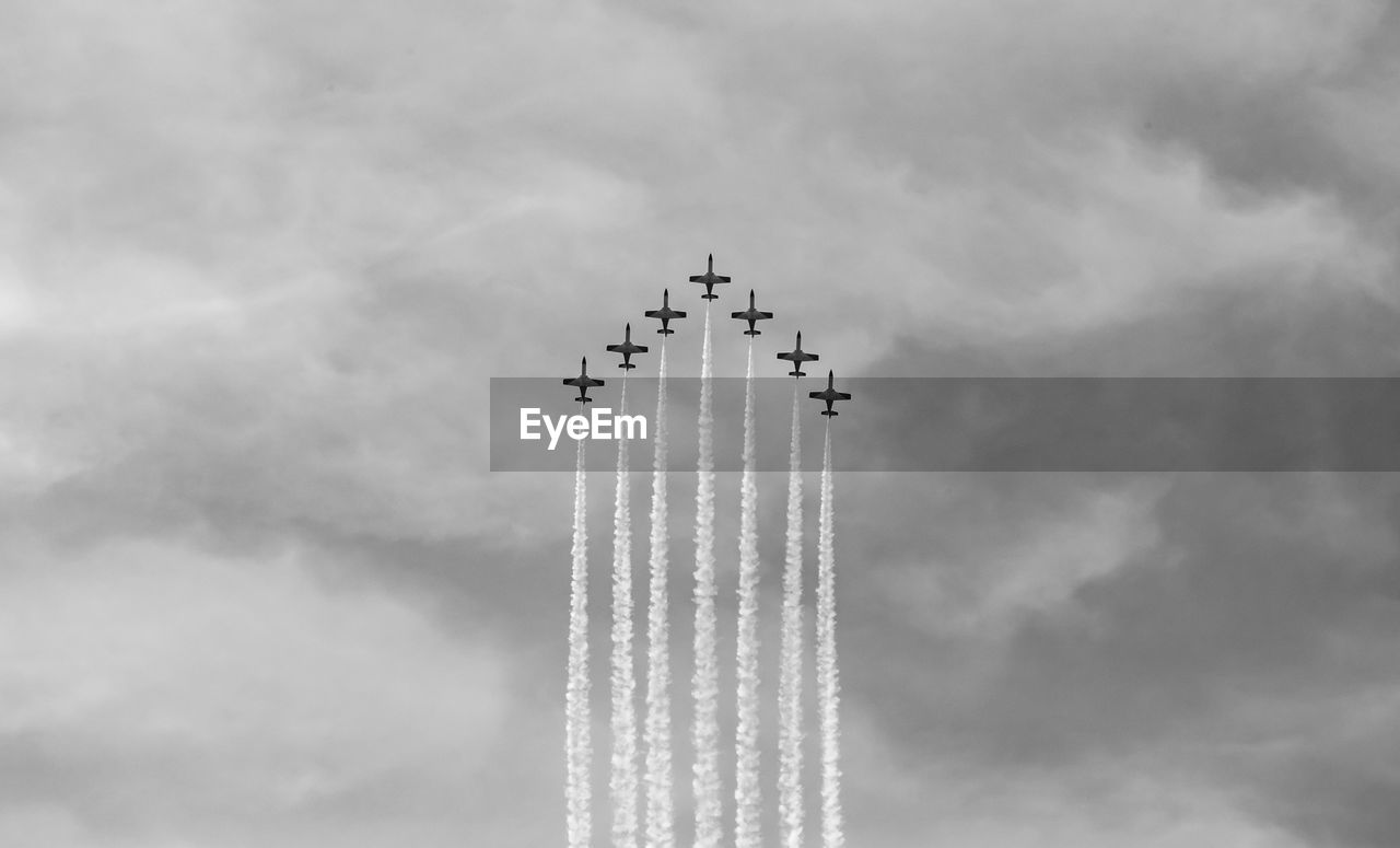 Low angle view of airplane flying against sky