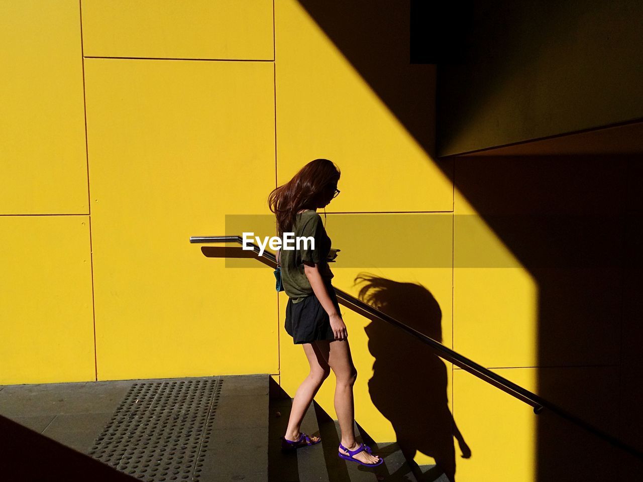 Woman walking down subway steps