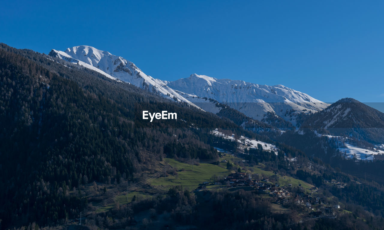 Scenic view of snowcapped mountains against clear sky