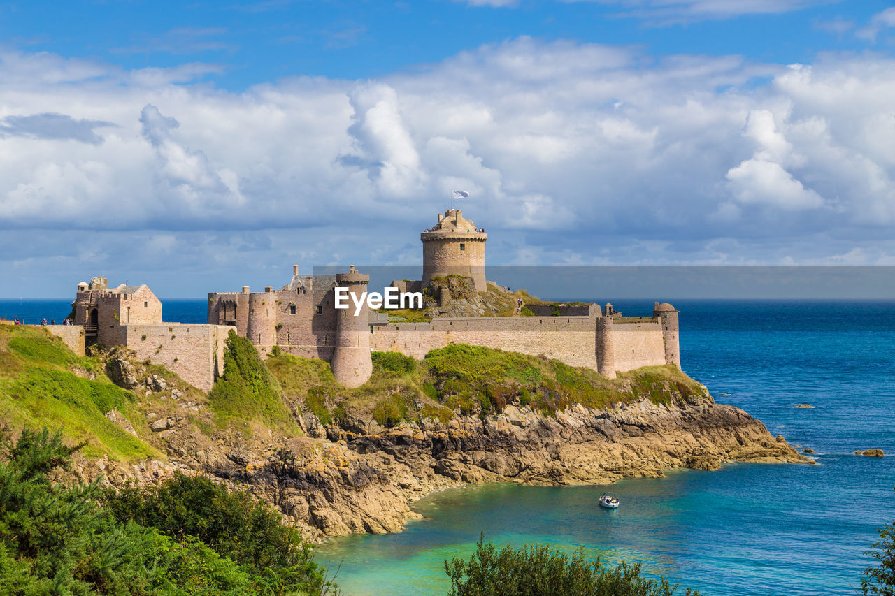 CASTLE BY SEA AGAINST SKY