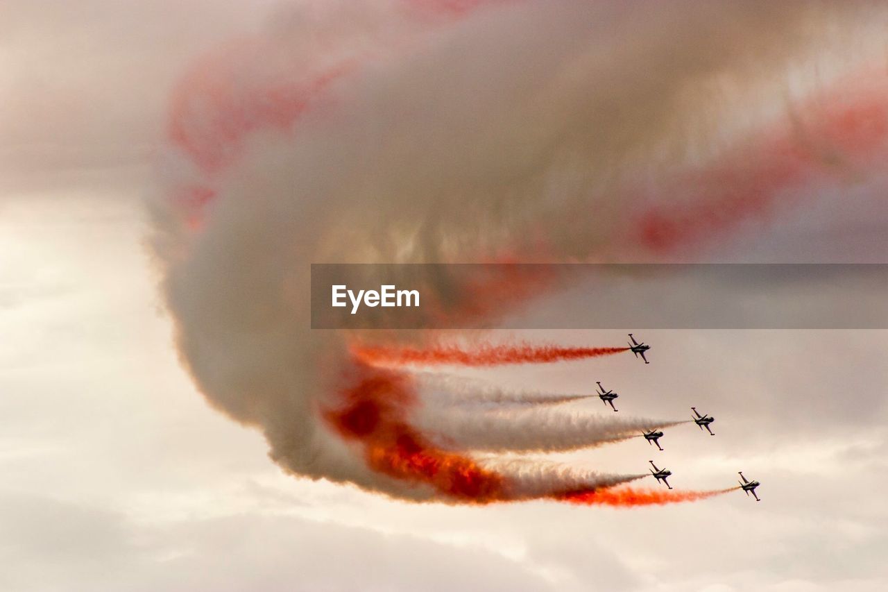 Low angle view of airshow against sky