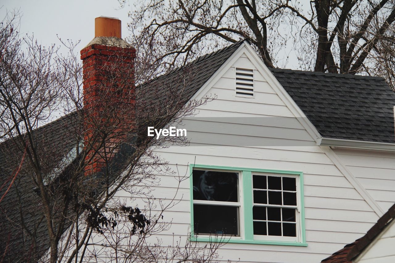 LOW ANGLE VIEW OF HOUSE DURING WINTER