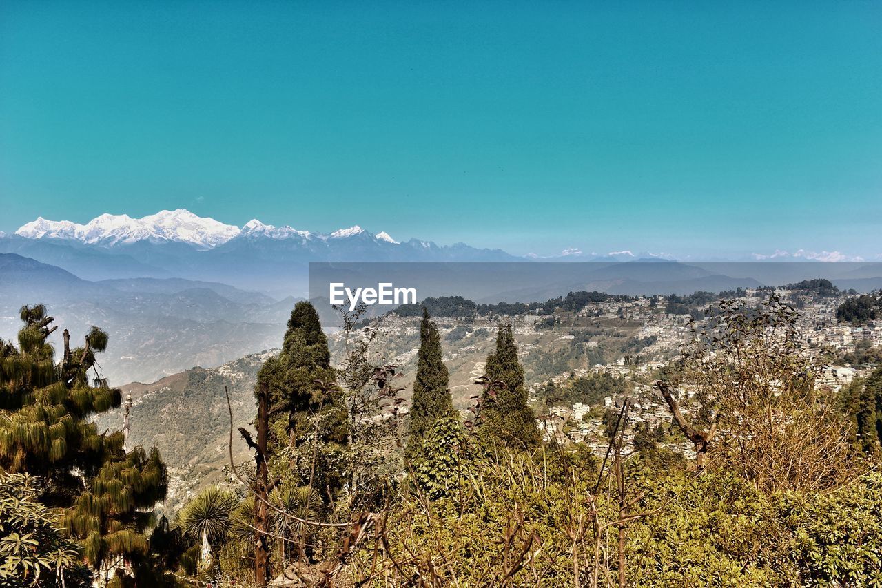 Scenic view of mountains against blue sky in darjeeling / india 
