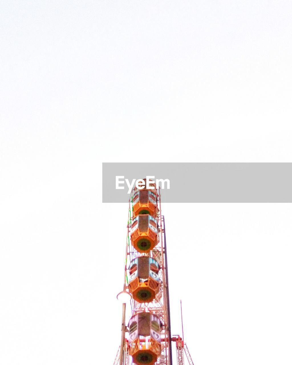 LOW ANGLE VIEW OF CAROUSEL AGAINST CLEAR SKY