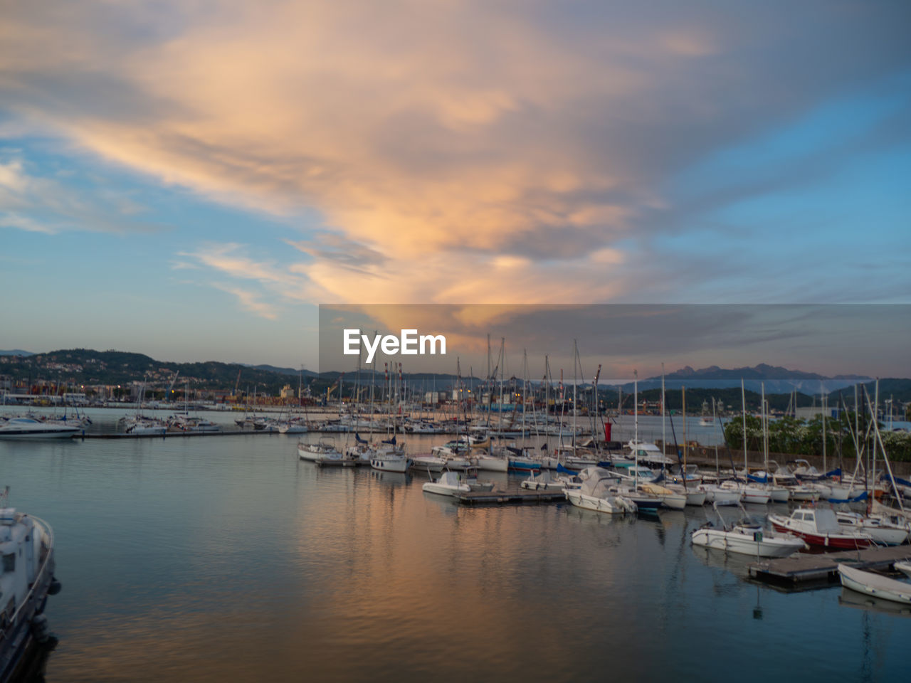 water, nautical vessel, sky, cloud, transportation, reflection, mode of transportation, harbor, ship, sea, sailboat, moored, nature, sunset, marina, evening, architecture, dusk, no people, mast, dock, vehicle, beauty in nature, travel destinations, city, building exterior, yacht, pole, travel, tranquility, scenics - nature, outdoors, built structure, boat, cityscape, pier, waterfront, tranquil scene, building, port, sailing, bay