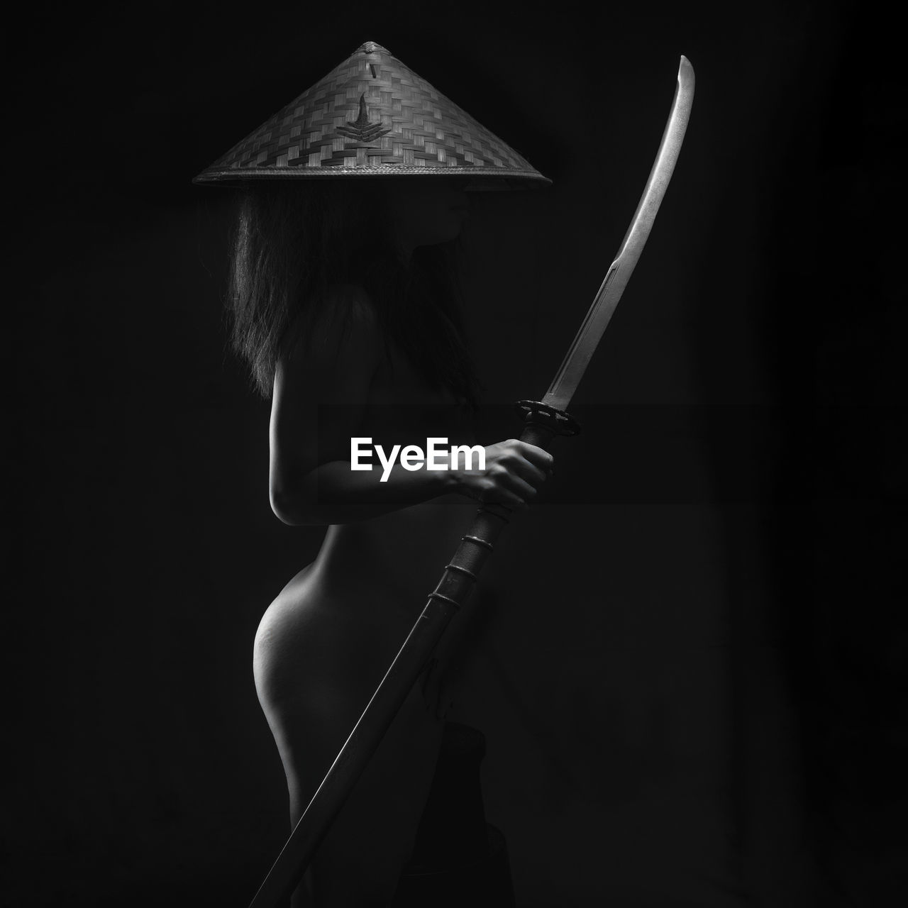 Rear view of woman standing against black background