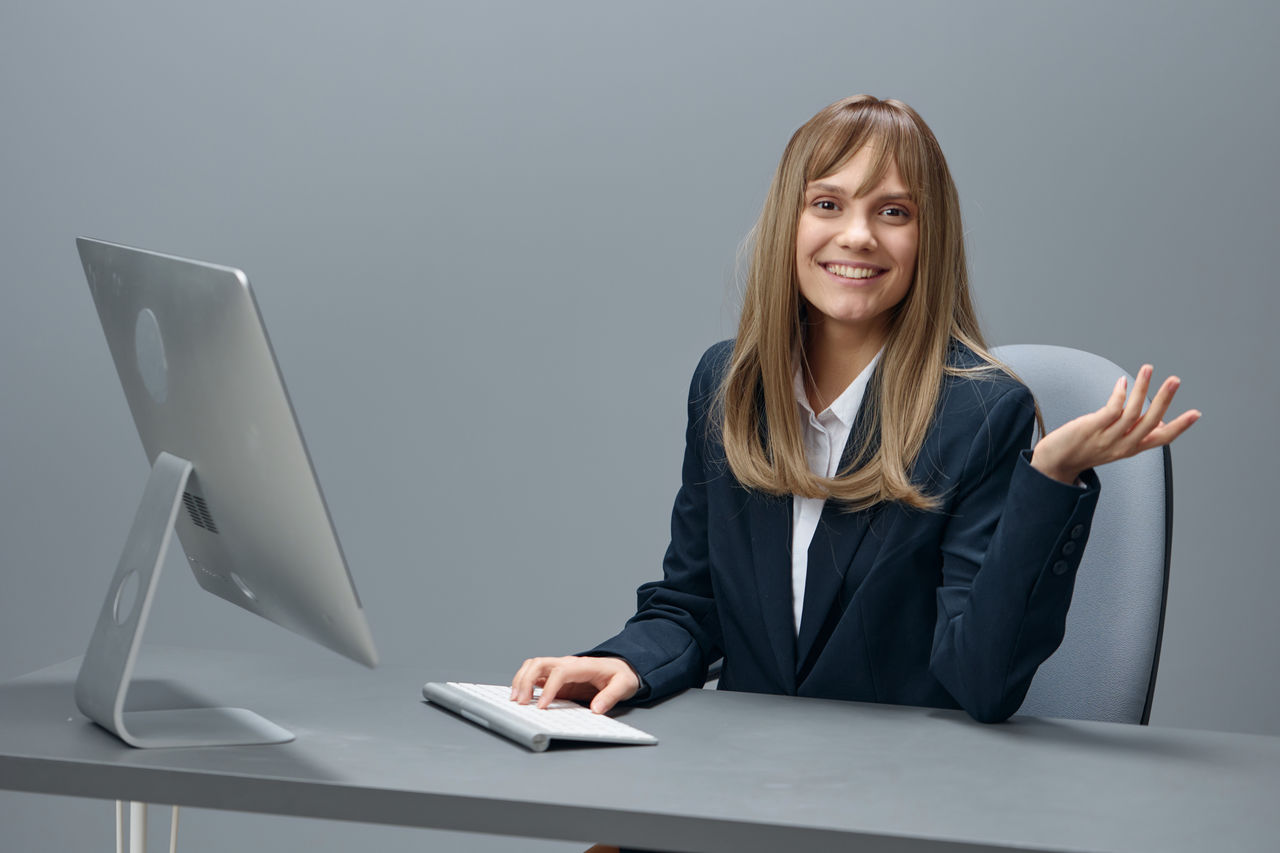 portrait of young businesswoman using laptop while sitting on table