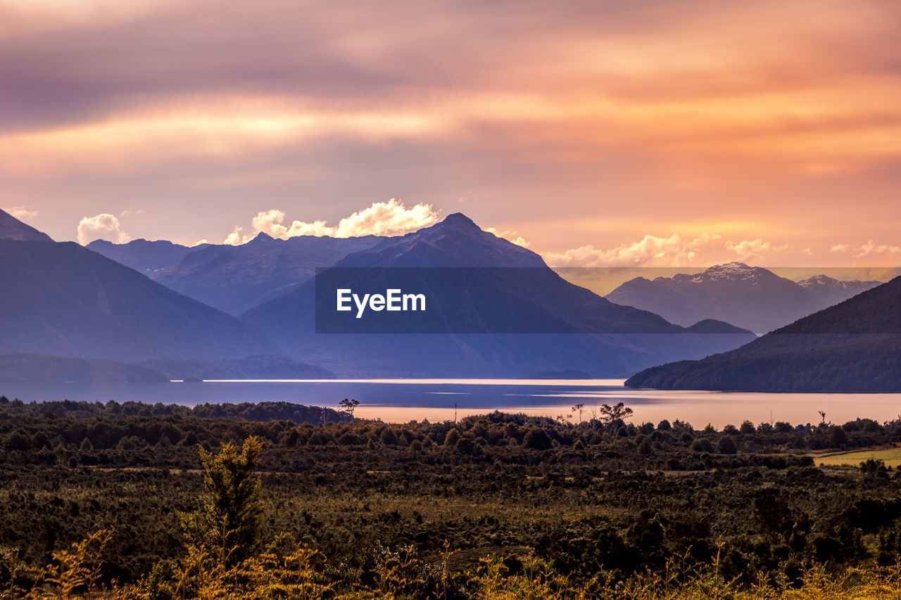 Scenic view of snowcapped mountains against sky during sunset