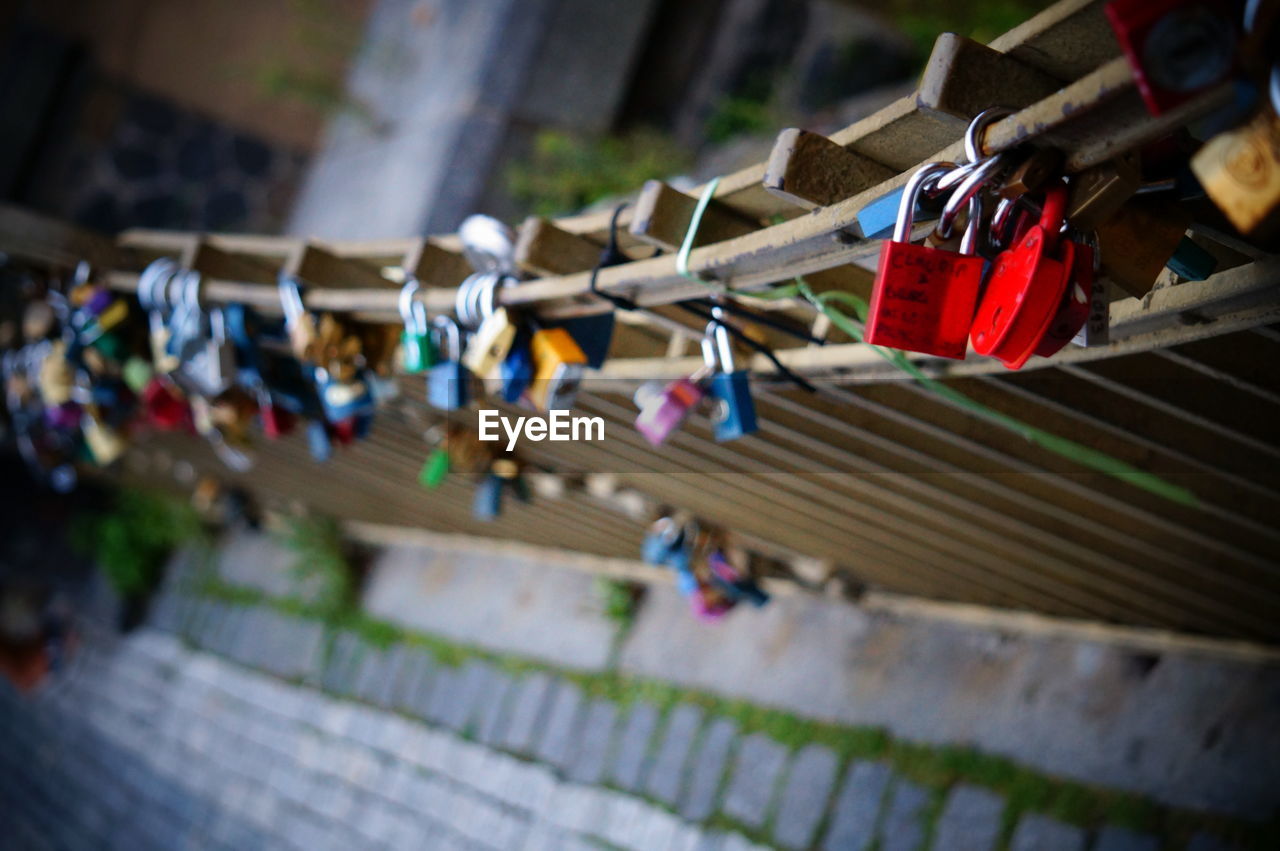 HIGH ANGLE VIEW OF PADLOCKS ON RAILING