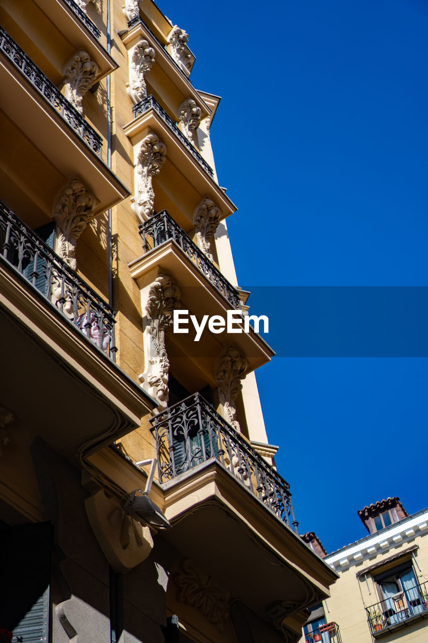 Low angle view of building against clear blue sky