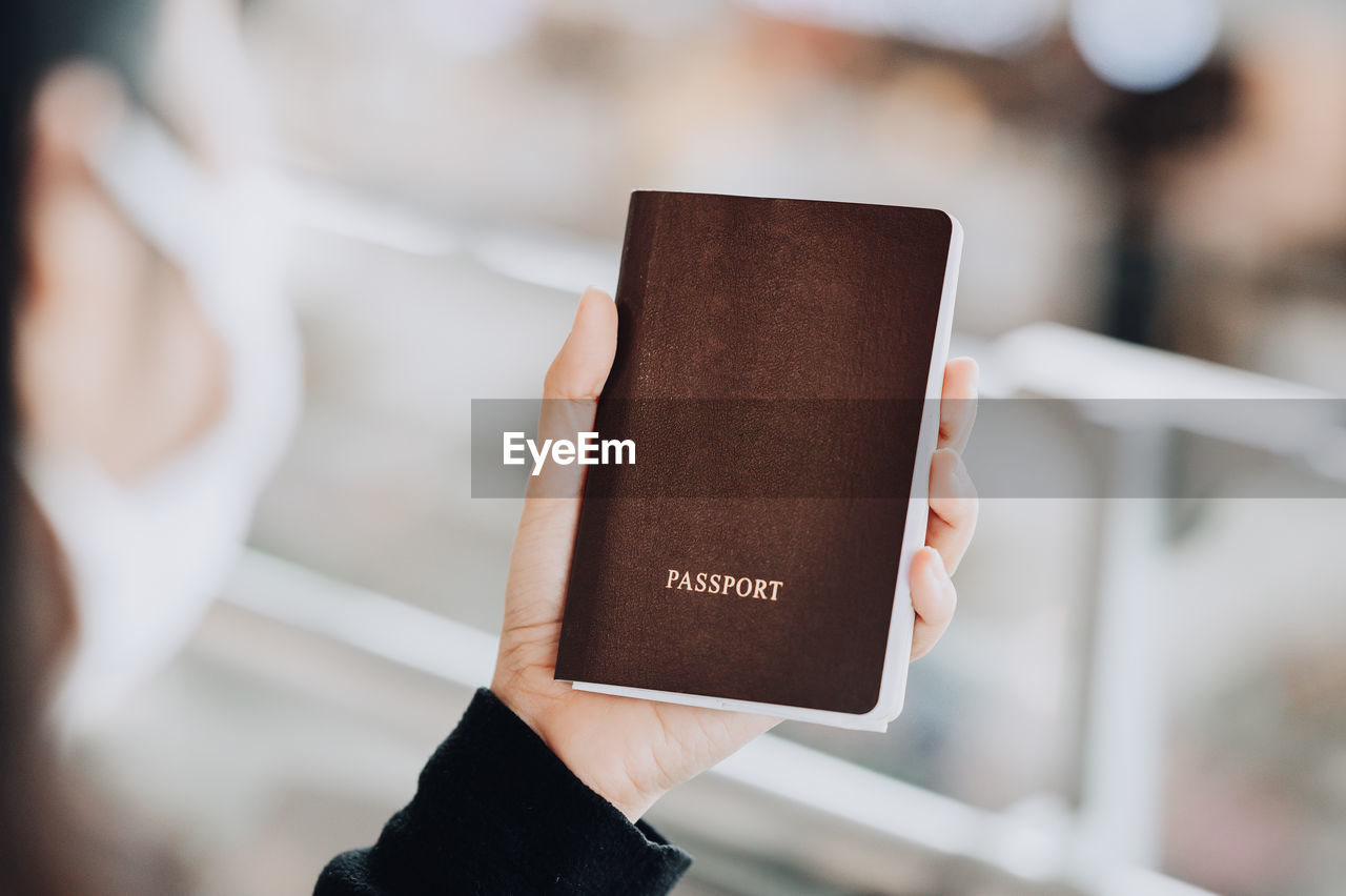 CLOSE-UP OF PERSON HOLDING BOOK