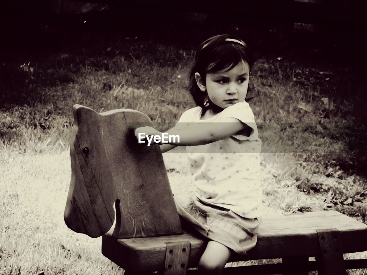 Girl riding on rocking horse at playground