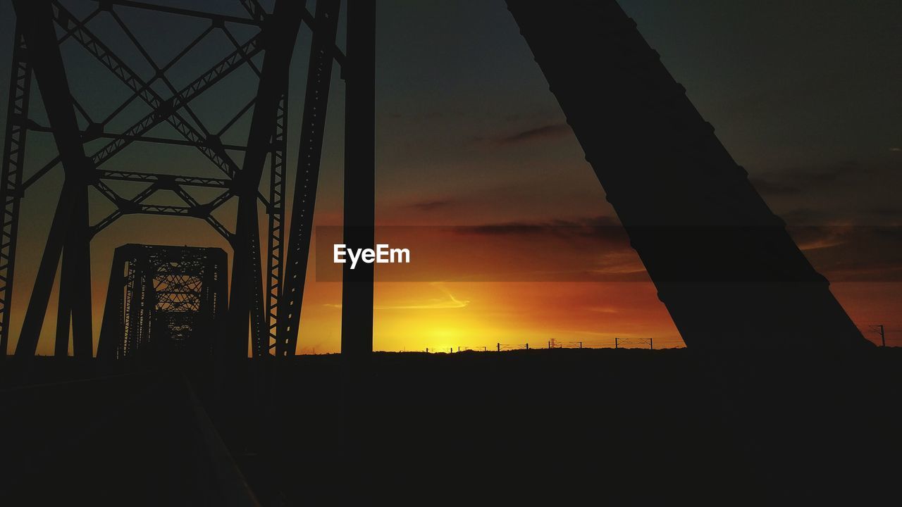 Silhouette of bridge against sky during sunset