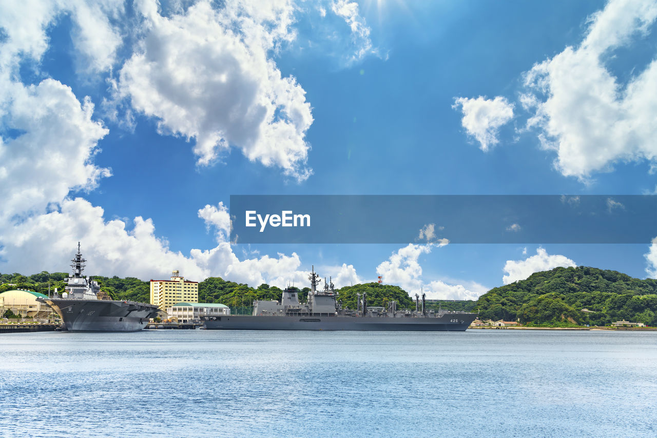 Replenishment oiler js masyu  and the destroyer js izumo  berthed in the yokosuka naval port.