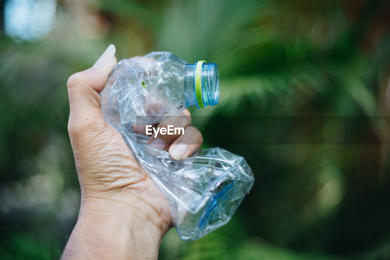 Close-up of hand holding plastic