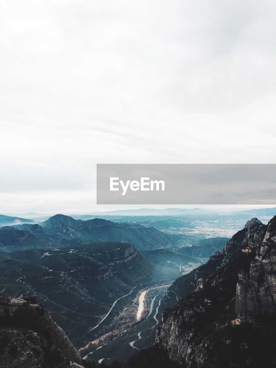 Aerial view of landscape against cloudy sky