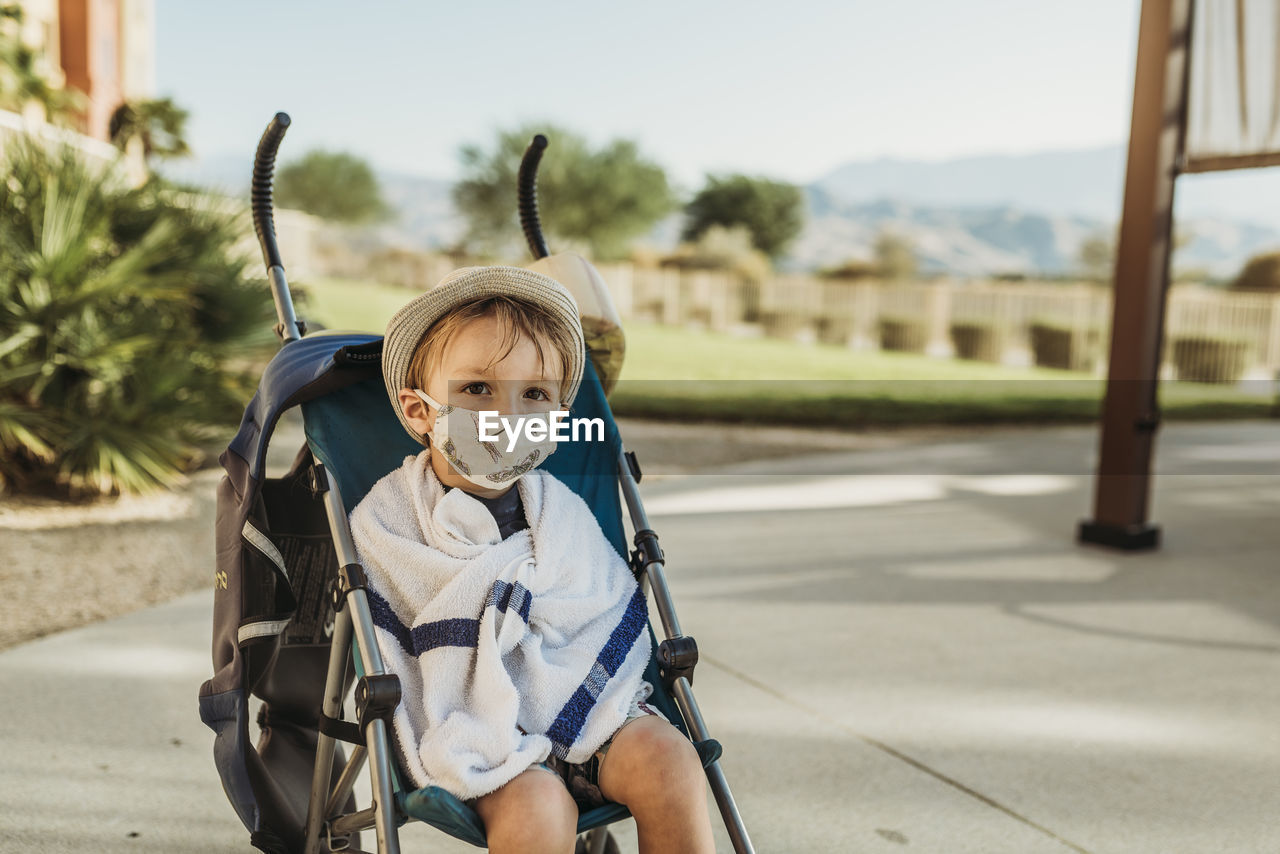 Portrait of young boy with mask on outside on vacation