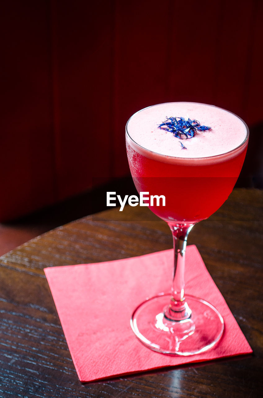 Close-up of red wineglass on table