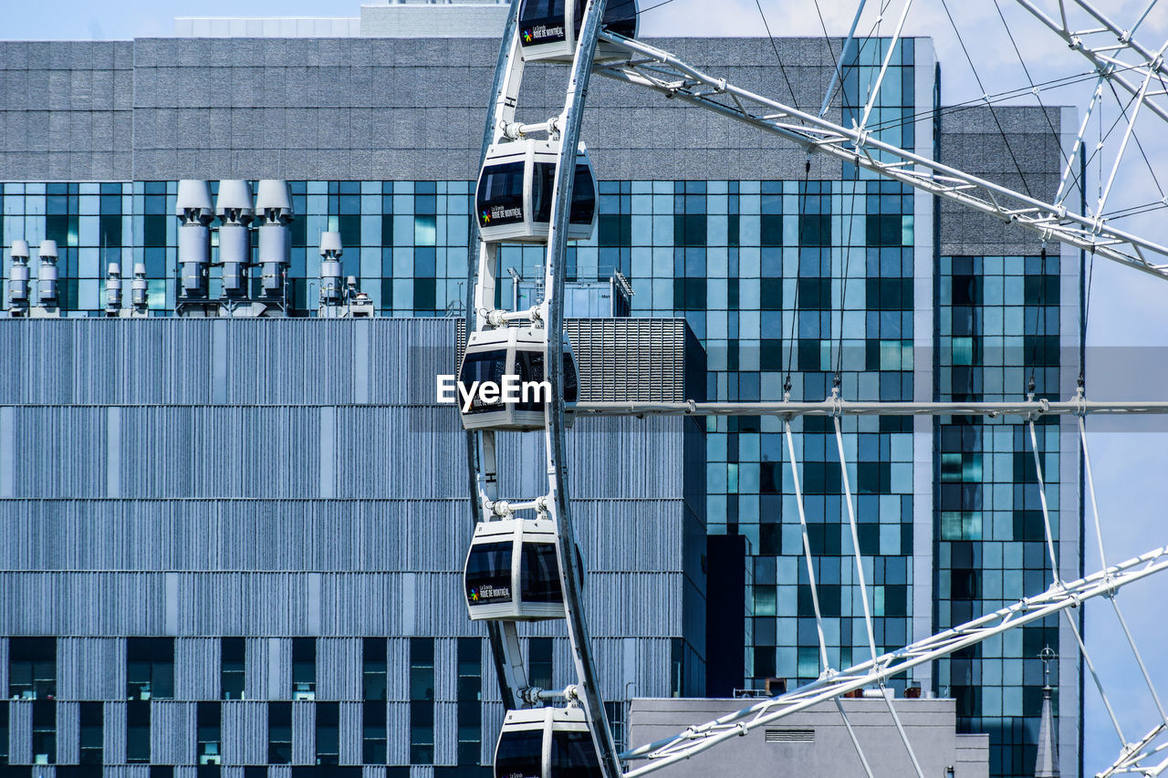 LOW ANGLE VIEW OF MODERN GLASS BUILDING