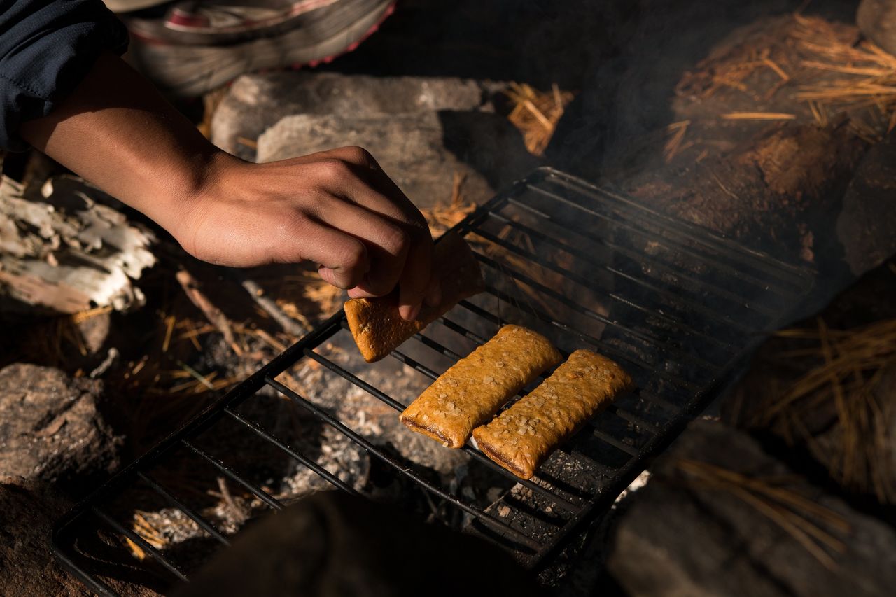 Hand of person cooking food