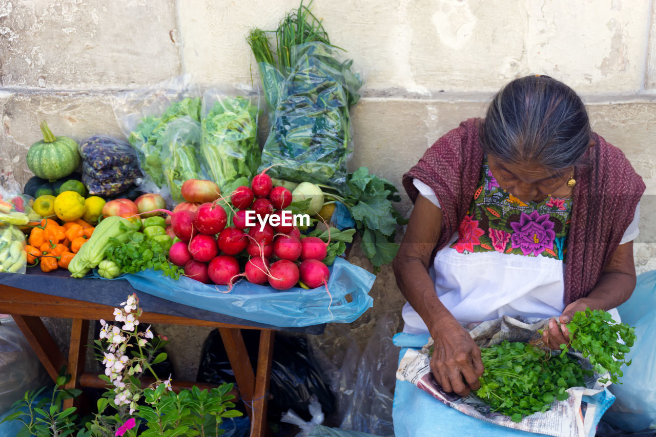 WOMAN WITH VEGETABLES IN MARKET