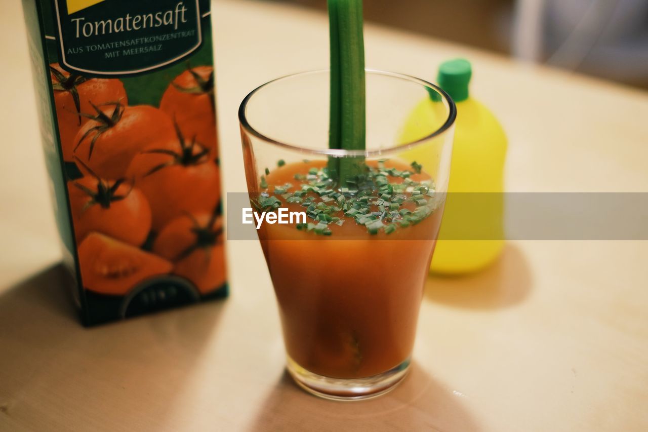 CLOSE-UP OF DRINK WITH JUICE ON TABLE