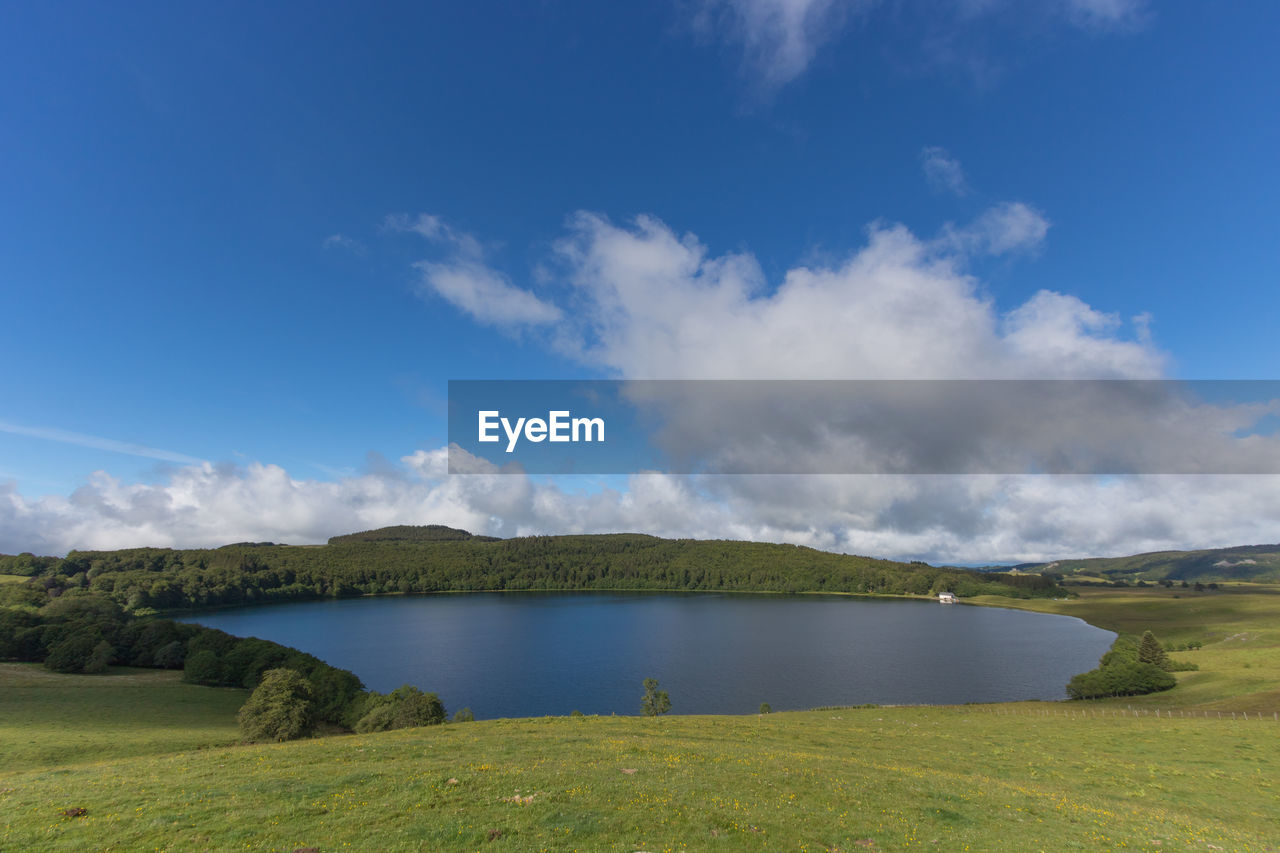 Scenic view of volcano lake against blue sky in massif central