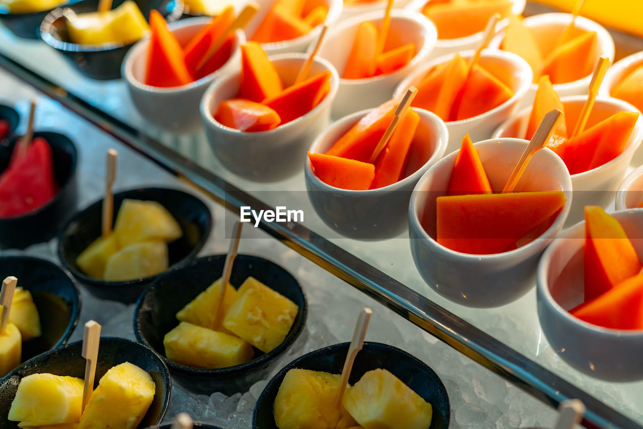 Tropical fruit buffet at event in restaurant. catering food. fresh papaya, pineapple and watermelon.