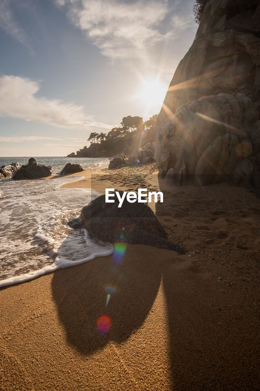 Scenic view of beach against sky during sunset