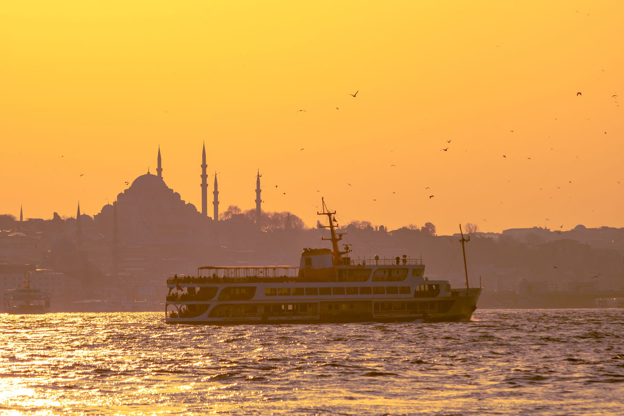 Ferry and suleymaniye mosque at sunset.