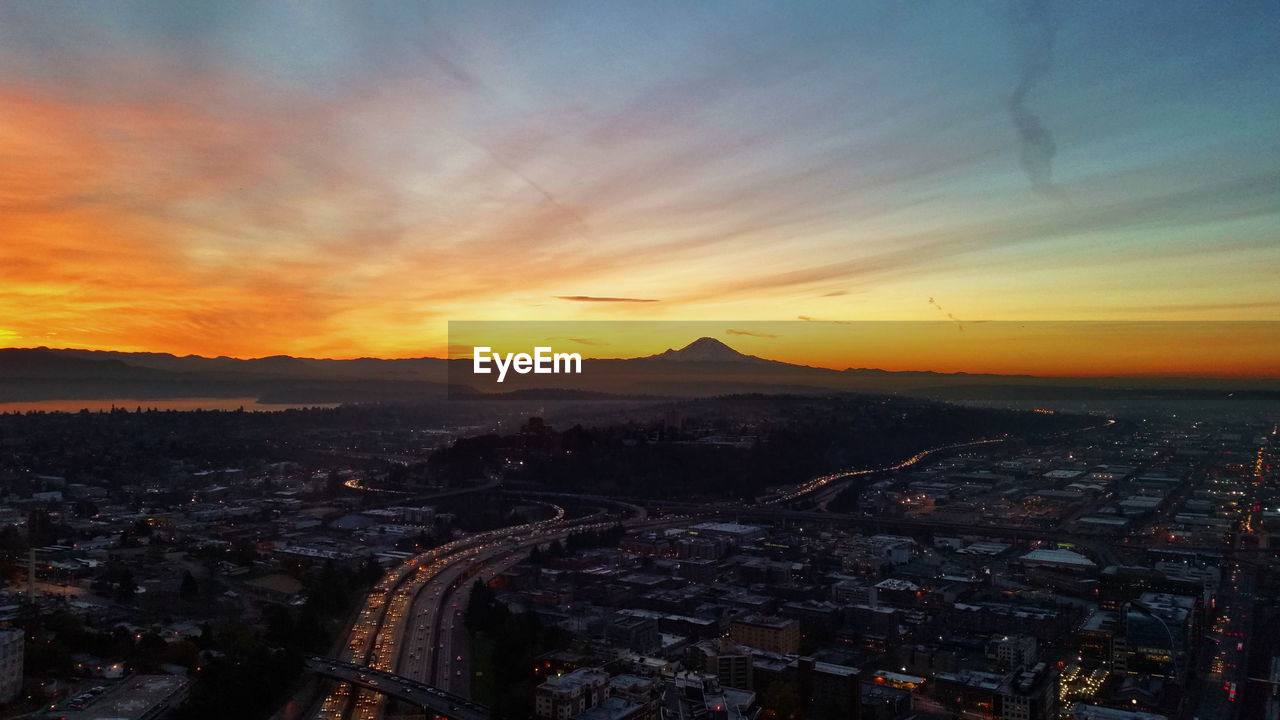 HIGH ANGLE VIEW OF CITYSCAPE AT SUNSET