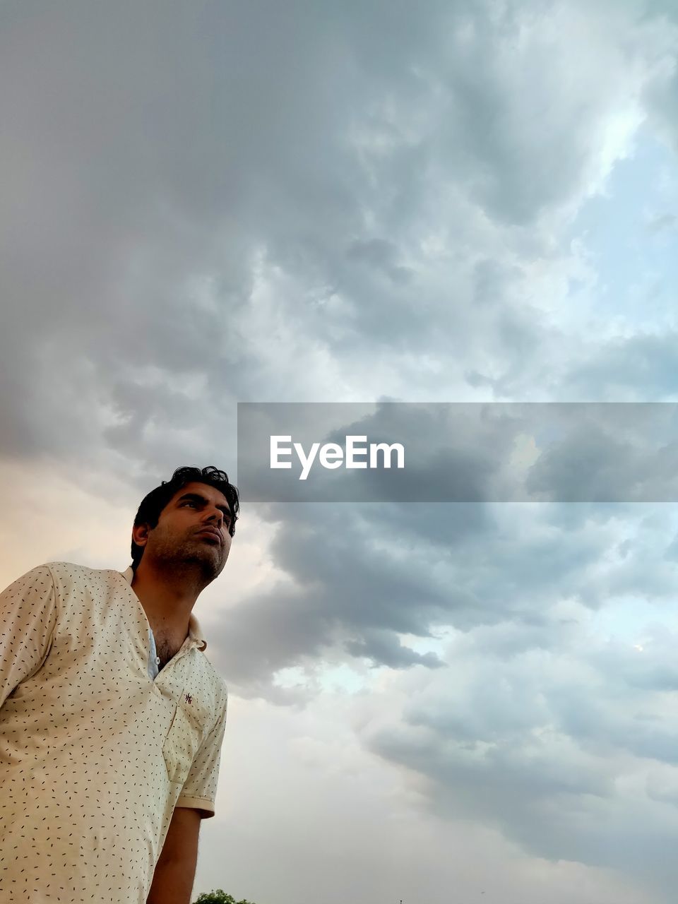 Low angle view of man standing against sky