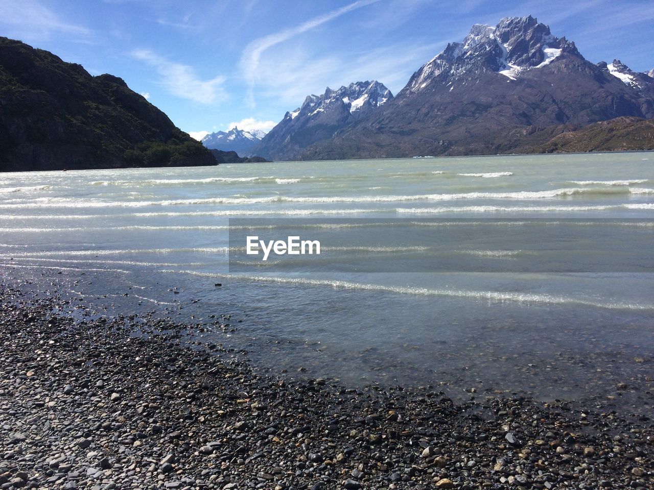 Scenic view of beach and mountains against sky